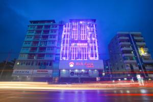 a building with aania bank lit up at night at Grace Treasure Hotel in Yangon