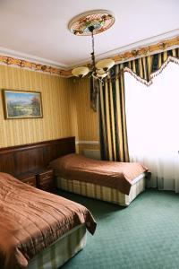 a hotel room with two beds and a window at Hotel Książę Poniatowski in Lesznowola