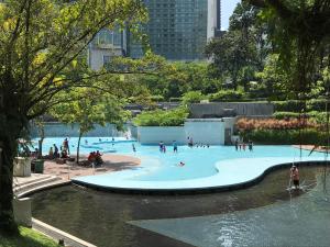 a group of people in a swimming pool in a city at KLCC Apartment in Kuala Lumpur