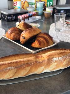 a table with two plates of bread and pastries at Chambres d'Hôtes Chez Florence in Montmerle Sur Saône +38 photos