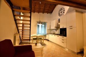 a kitchen with a staircase and a living room at B&B Il Borgo Fiorito in Lerma