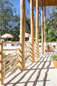 a row of wooden walkways leading up to a balcony at The Nomadic Hotel in Nosara