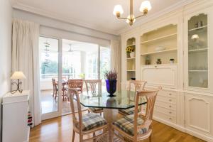 a dining room with a glass table and chairs at Villamar - Relax, Sol y Playa in Alicante