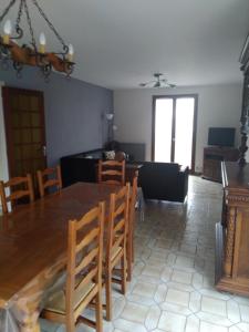 a dining room and living room with a table and chairs at La maison de Jacques in Villiers-en-Morvan +4 photos