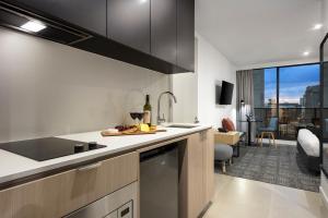 a kitchen with a sink and a counter top at Quest NewQuay in Melbourne