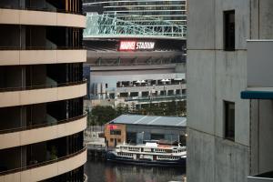 a view of a river between two tall buildings at Quest NewQuay in Melbourne