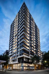 a tall building with many windows on a street at Quest NewQuay in Melbourne