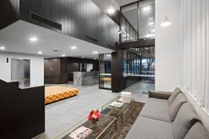 a living room with a couch and a table at Quest NewQuay in Melbourne