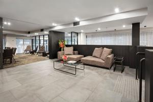 a living room with a couch and a table at Quest NewQuay in Melbourne