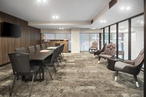 a conference room with a long table and chairs at Quest NewQuay in Melbourne