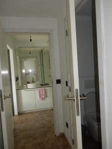 a bathroom with a sink and a toilet and a mirror at TERRASSES DE MALMEDY Triplex 259 " C EST LA VIE " in Malmedy