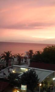a view of the ocean at sunset from a building at STUDIO MARGARITA in Nea Plagia