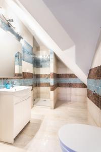 a bathroom with a white sink and a toilet at roomsy guest house in Sopot +72 photos