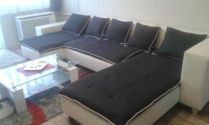 a couch with pillows in a living room at Home in Zalaegerszeg