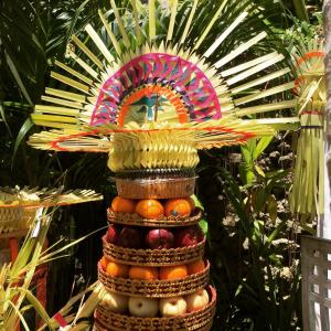 a tower of fruit with a hat on top of it at Villa Una in Seminyak