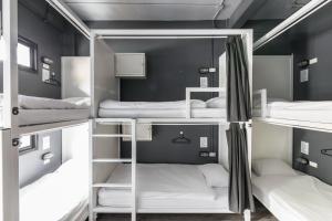 a group of bunk beds in a room at The Cocoon Hostel in Bangkok
