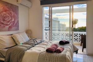 a bedroom with a bed and a large window at Seaview 3 bedroom Kings Road Penthouse in Paphos City