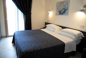 Postel nebo postele na pokoji v ubytování Residence Mareamare
