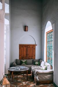 a living room with a couch and a table at Riad Le Rihani in Marrakech
