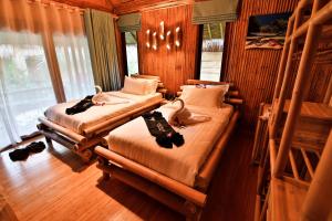 a room with two beds and a chandelier at Phi Phi CoCo Beach Resort in Phi Phi Islands +37 photos