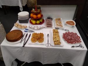 a white table with food on top of it at Posada Miranda in Miranda del Castañar