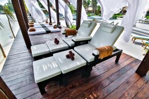 a porch with white furniture on a wooden deck at Phi Phi CoCo Beach Resort in Phi Phi Islands