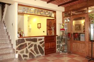 a lobby of a restaurant with a reflection in the mirror at La Alquería de Manu - venta el Laminador in Riópar