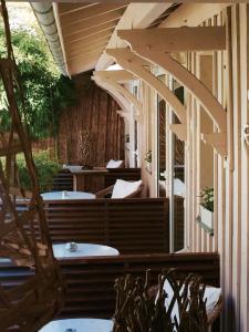 une terrasse avec des arches et des tables blanches dans l'établissement Maison du Lierre Bordeaux Centre ville, à Bordeaux