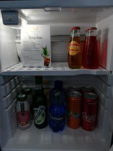 a refrigerator filled with lots of drinks and sodas at Blue Moon Hotel in Pantelleria