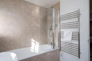 a bathroom with a shower and a sink at Ogilvie Lodge Apartment in Thorpeness +16 photos