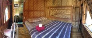 a bedroom with a bed with a candle on it at Fundee Story Guesthouse Bamboo House in Chiang mai old town in Chiang Mai