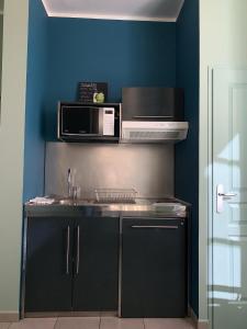 a kitchen with a sink and a microwave at Sunny Studio Vieux Port in Marseille