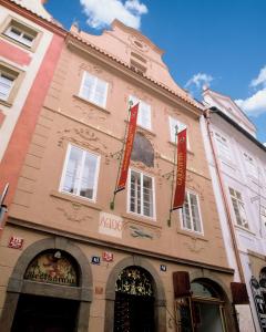 a building with red signs on the front of it at Hotel Residence Bijou de Prague in Prague