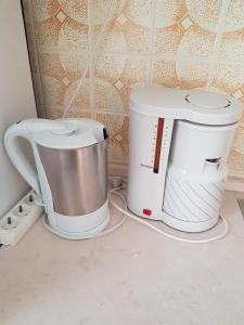 two white appliances sitting on a kitchen counter at Apartman Maslov in Duće