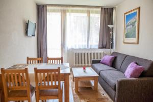 a living room with a couch and a table at Apartmany Belianky in Tatranská Lomnica