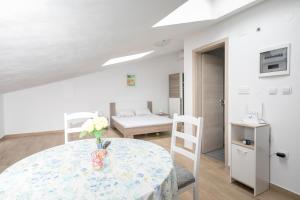 a room with a table with a vase of flowers on it at Apartment Elena in Bale