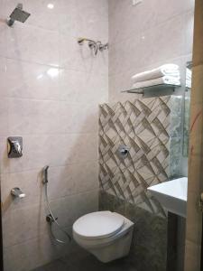a bathroom with a toilet and a sink at Hotel Suryansh in Udaipur +26 photos