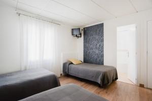 Łóżko lub łóżka w pokoju w obiekcie Hotel El Cid