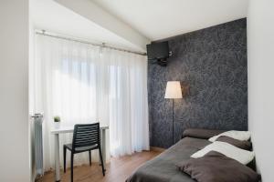 Łóżko lub łóżka w pokoju w obiekcie Hotel El Cid