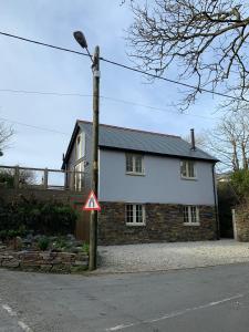 a house with a street light in front of it at Bossiney Cove Cottage in Tintagel