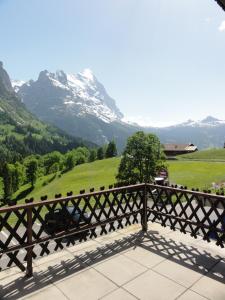 a view of a mountain from the balcony of a house at Hotel Blümlisalp in Grindelwald