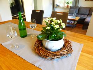 a table with a potted plant and two wine glasses at St. Petershof in Winningen