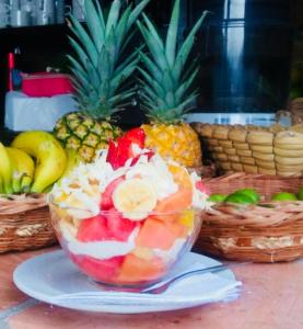 a bowl of fruit on a plate on a table at La Serrana Hostal Spa in Socorro