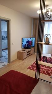 a living room with a flat screen tv on a table at Girelės apartamentai in Kaišiadorys