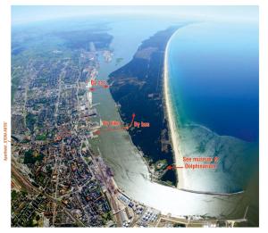 an aerial view of the mouth of a river and the ocean at Aparthotel Stora Antis in Klaipėda