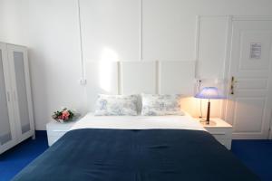 a bedroom with a large bed with a blue blanket at Olympia Hotel in Genoa