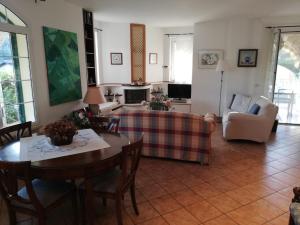 sala de estar con sofá, mesa y sillas en Villa Margot a Garlenda, en Garlenda
