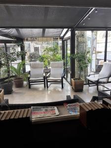 a living room with two chairs and a table at H&ocirc;tel Belleville in Lamalou-les-Bains