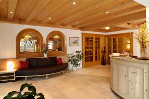 a living room with a couch and a table at Hotel Talblick in Ortisei