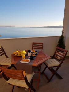 a table with a plate of food on top of a balcony at Casa Punta in Barić Draga